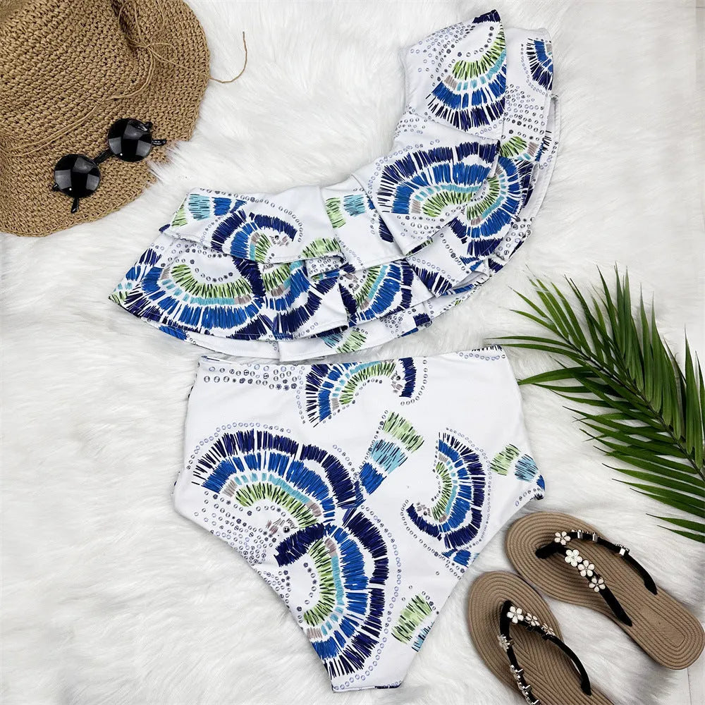 White women's one-shoulder swimsuit with large lotus leaf design and side split, double-layer front for coverage.