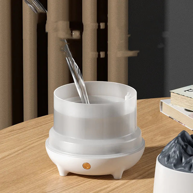 Volcano-shaped humidifier with flaming mountain design in white colour showing mist emission