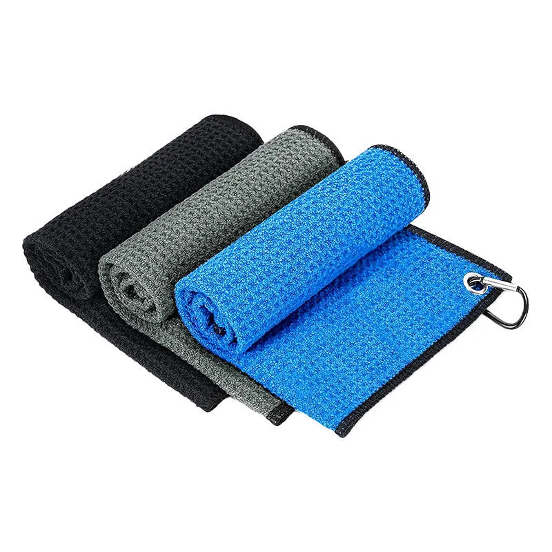 Waffle weave golf ball cleaning cloth in red, showing textured surface and hemmed edges.