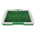 Green artificial grass dog toilet training tray with three-layer construction on a balcony.