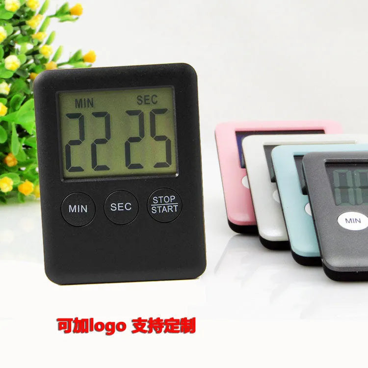 Black and white kitchen timer with magnetic back showing dial interface for 60-minute timing