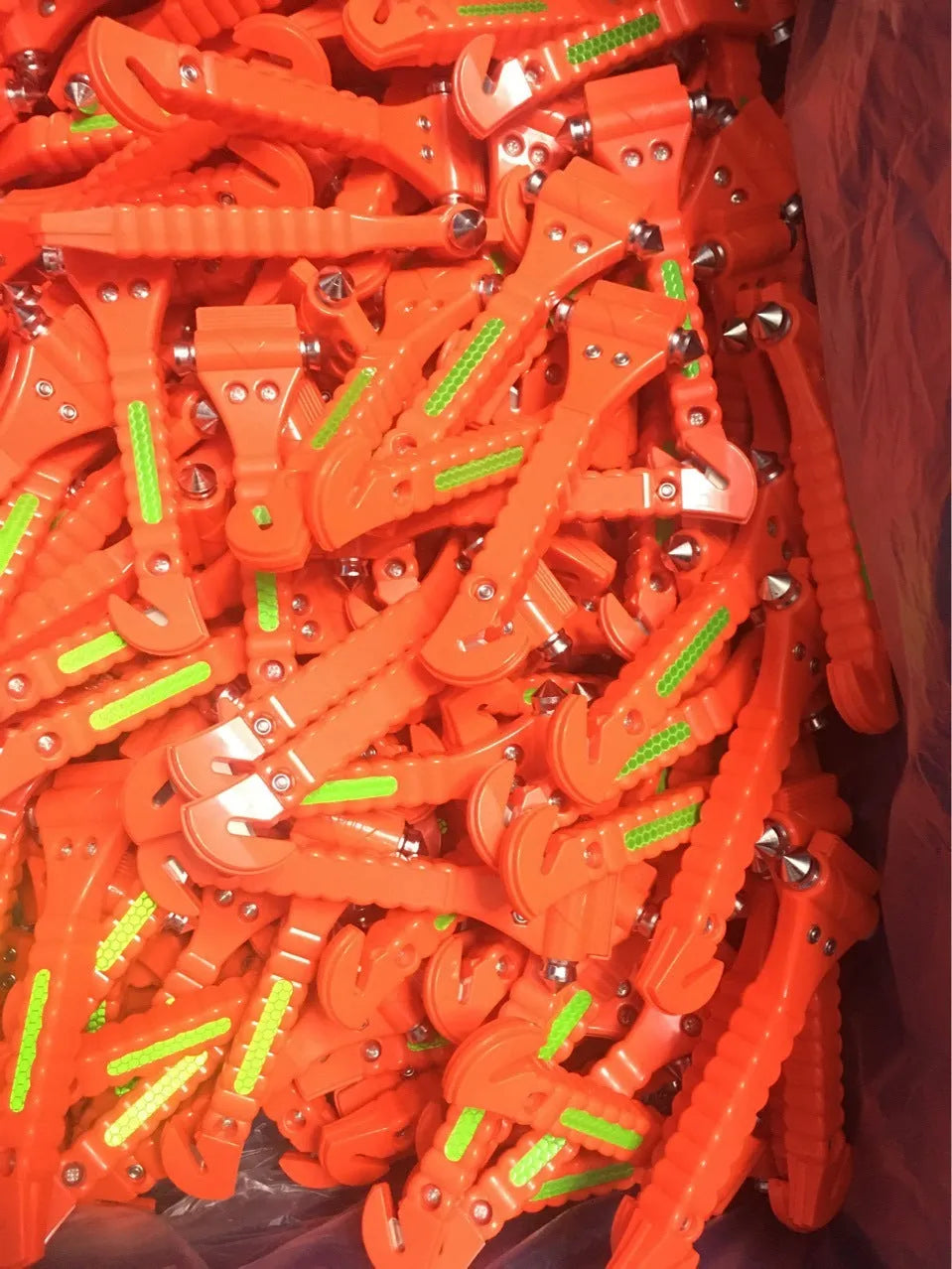 Red car emergency escape hammer with seatbelt cutter, made from ABS and carbon steel.