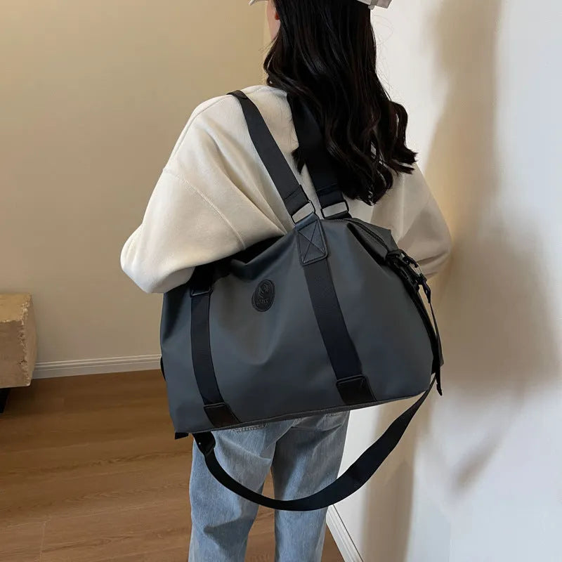 Large black waterproof Oxford cloth travel rucksack with multiple compartments shown on a grey background.