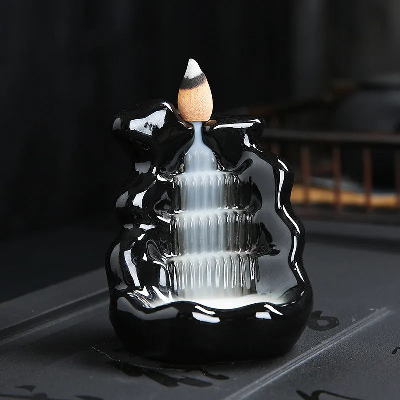 Modern ceramic backflow incense burner with sandal ornament in green tree design.