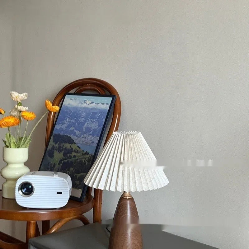 Nordic retro ceramic bedside table lamp with a pleated tapered floral fabric shade on a ceramic base.