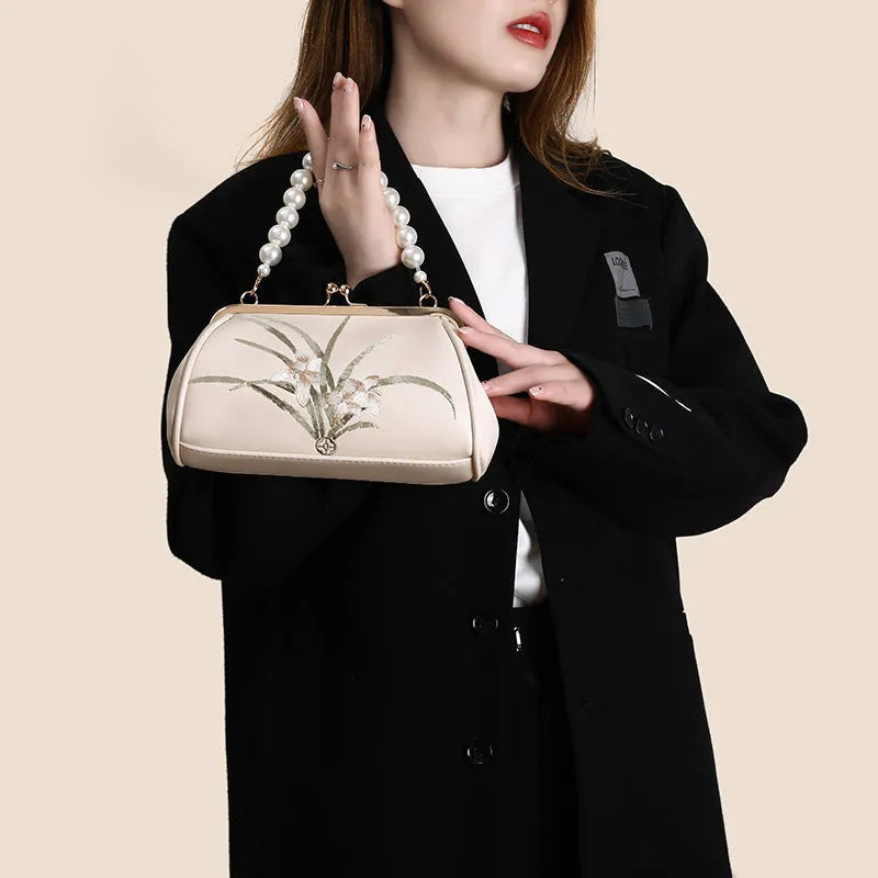 Beige women's embroidered shoulder bag with shell shape design in soft PU material