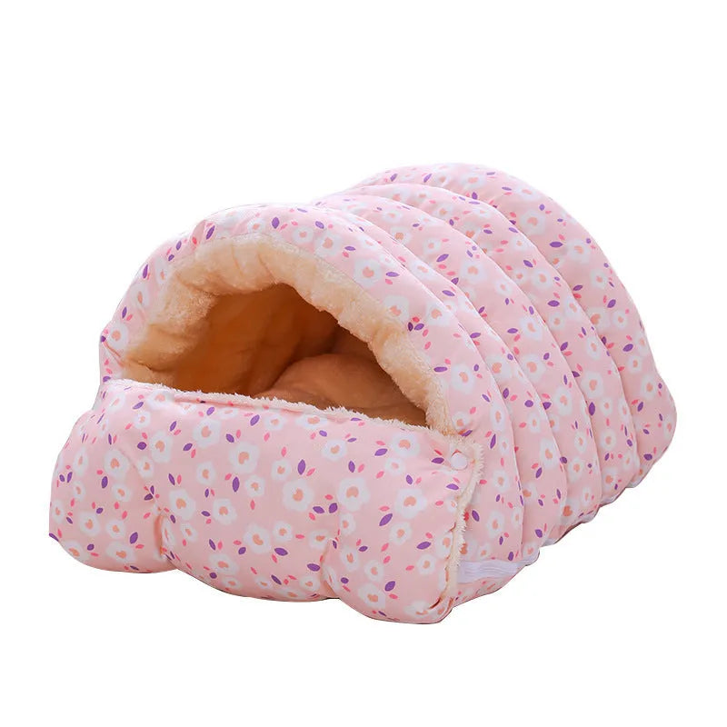 Closed cloth cat bed with removable cushion in a pink small flower pattern.