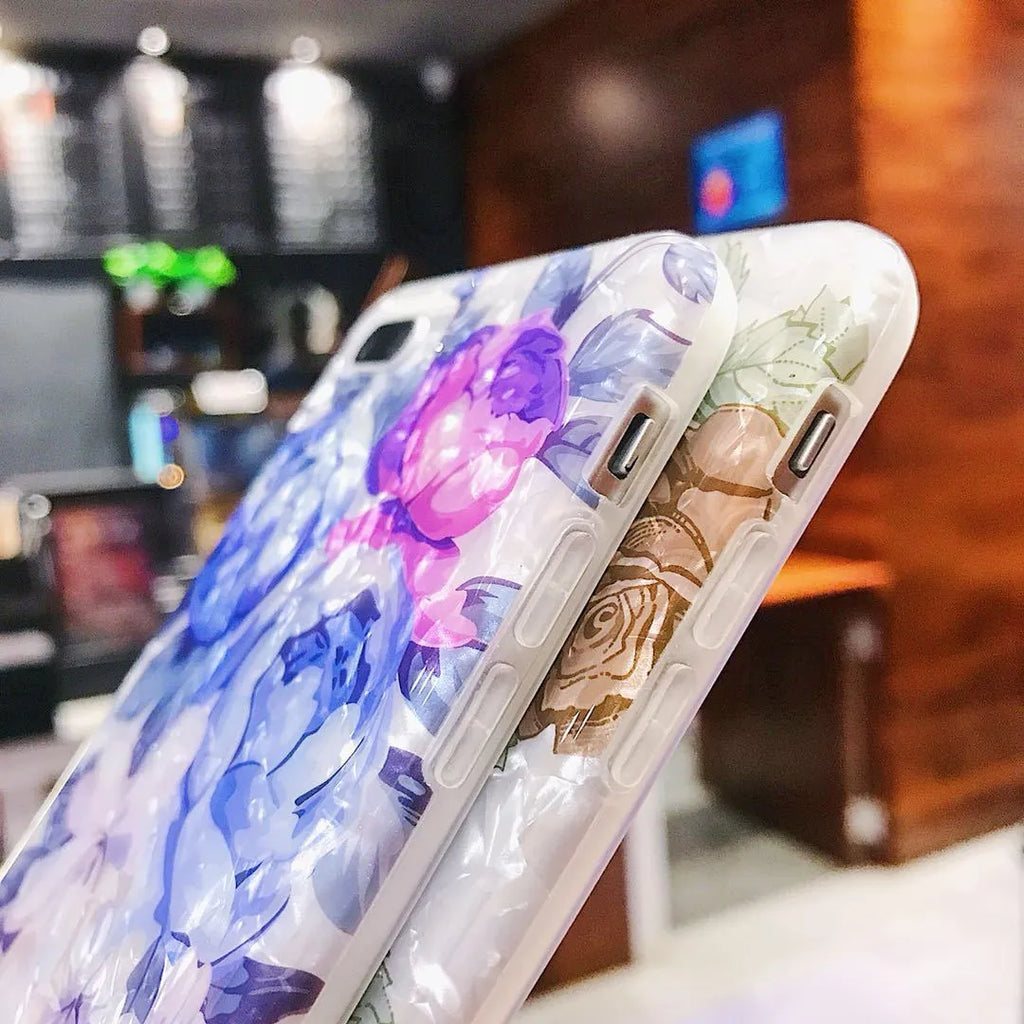 Soft TPU iPhone case with a rose flower design on the back, shown in brown.