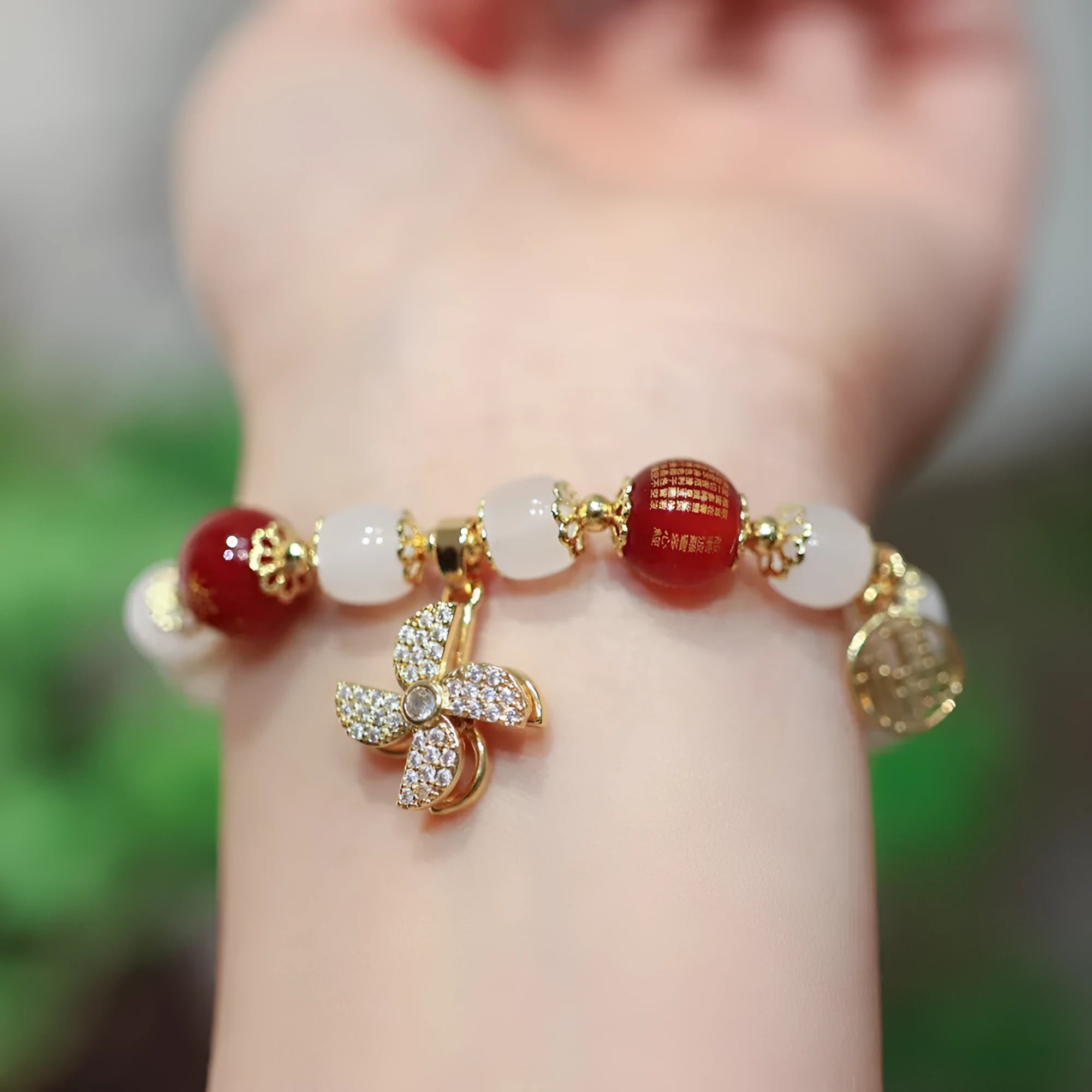 Chinese style coloured glaze bracelet with glass safety lock charms and windmill bead design