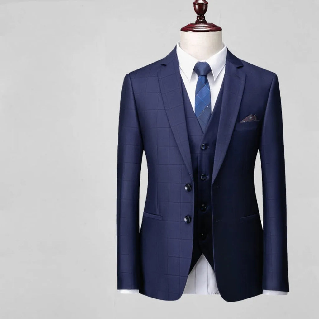 Men's navy blue three-piece slim fit suit with jacket, vest, and trousers on hanger