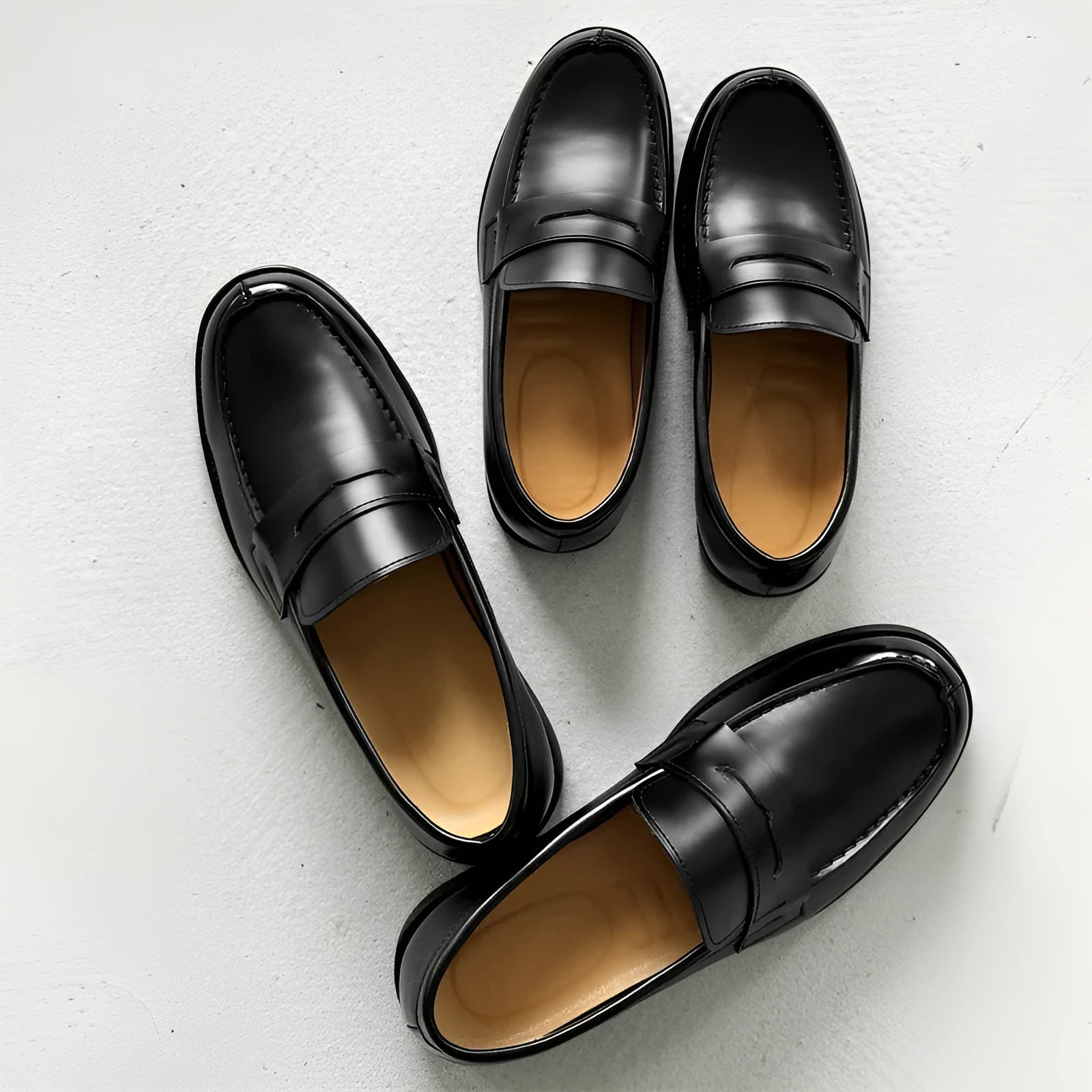 Black men's leather slip-on derby shoes on a white background