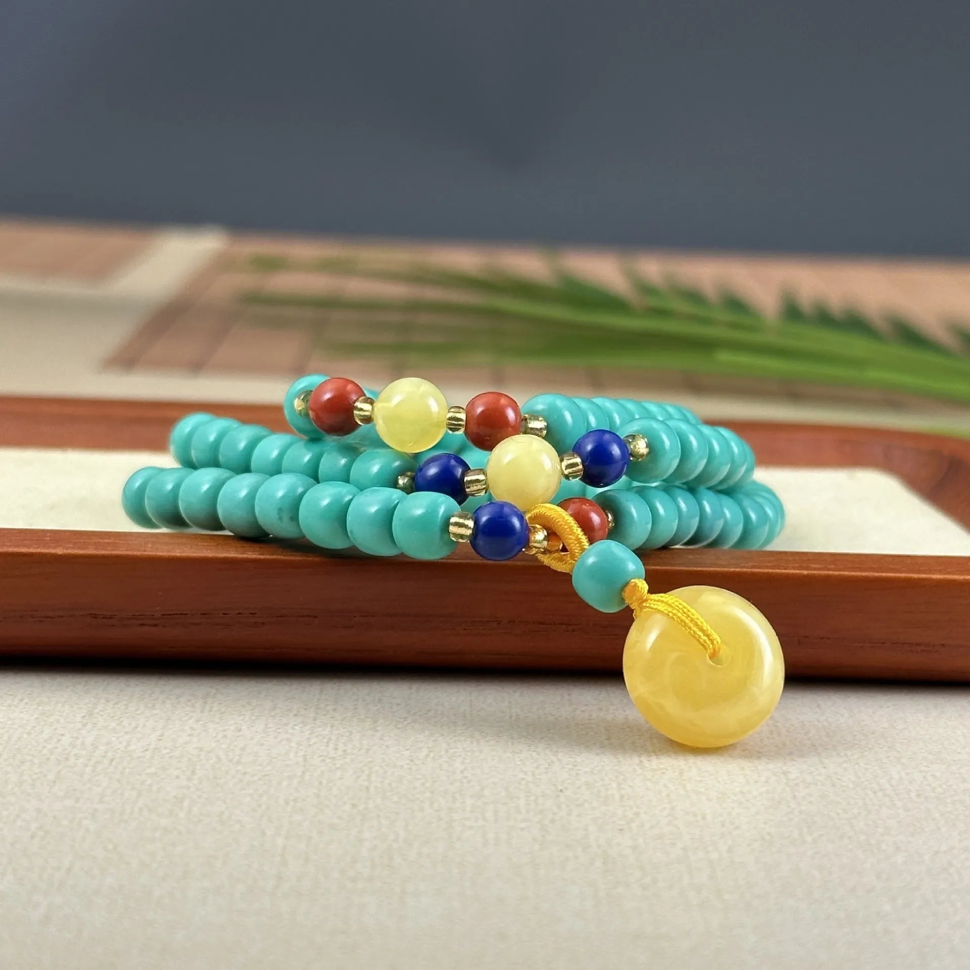 Turquoise mesh flower pendant necklace with adjustable ball bead chain showing hand-woven texture detail