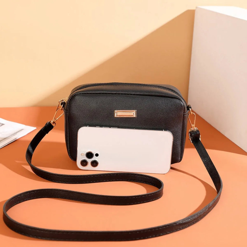 Women's solid colour PU shoulder bag with three-dimensional pocket in orange red, showing horizontal square shape and urban simplicity style