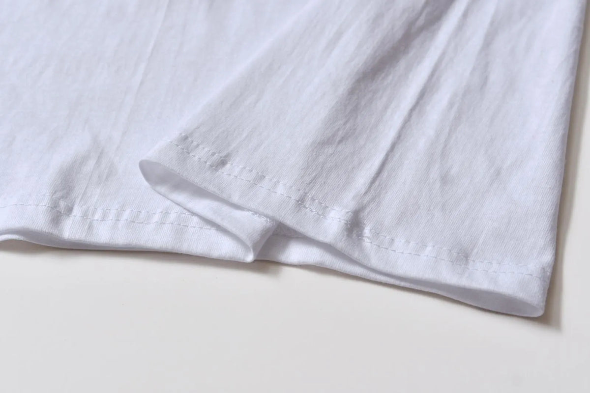 White cotton t-shirt overalls with round neck and short sleeves in patterned design