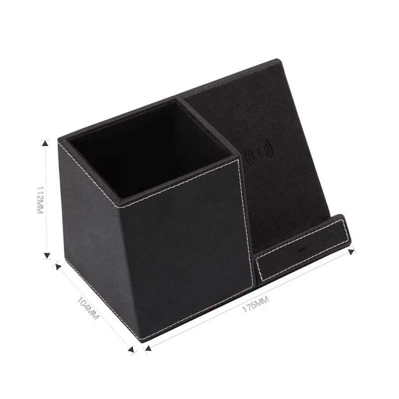 Black leather pen holder wireless charger on desk with phone charging and pens stored