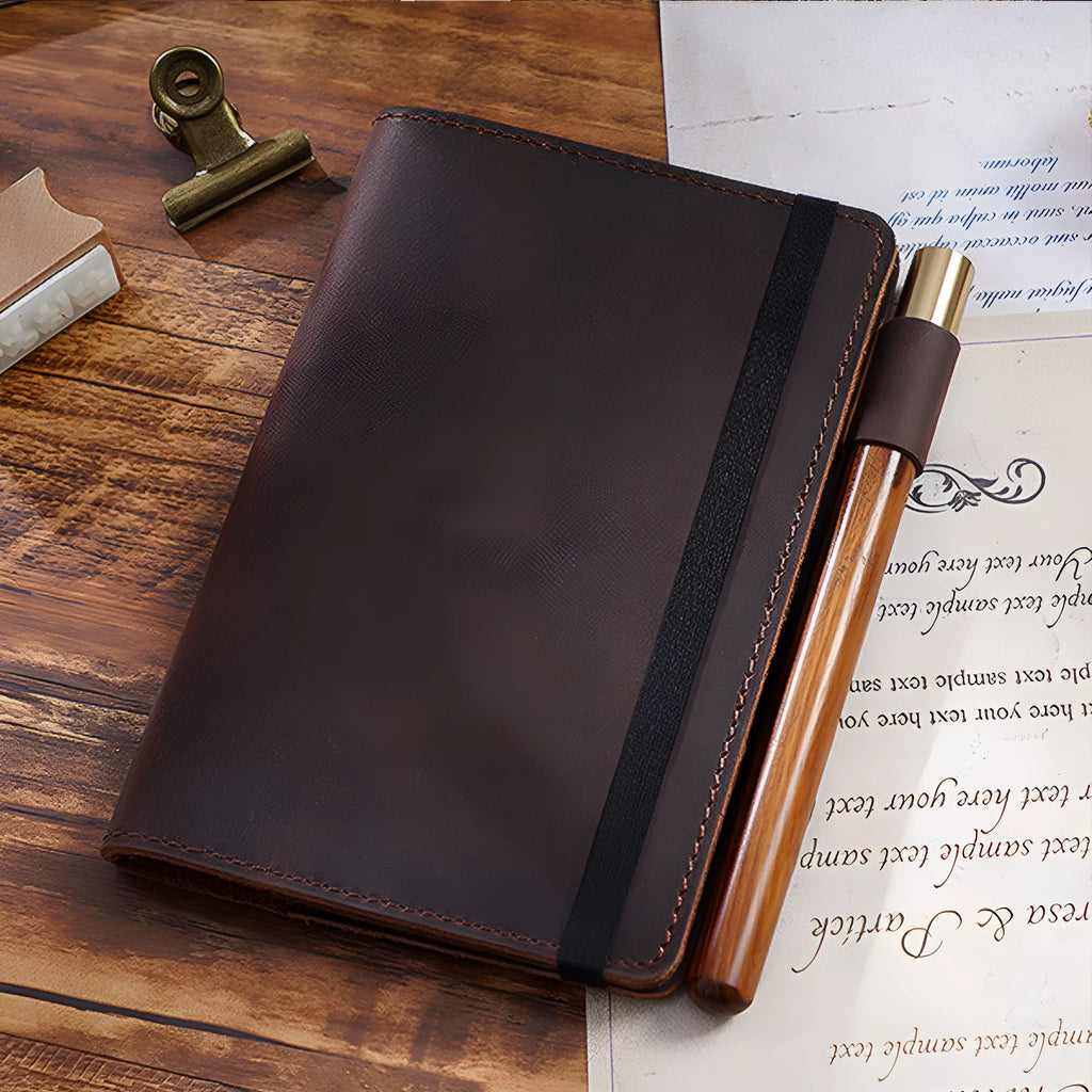Handmade leather kraft notebook open showing wood-free paper with dark green cowhide cover