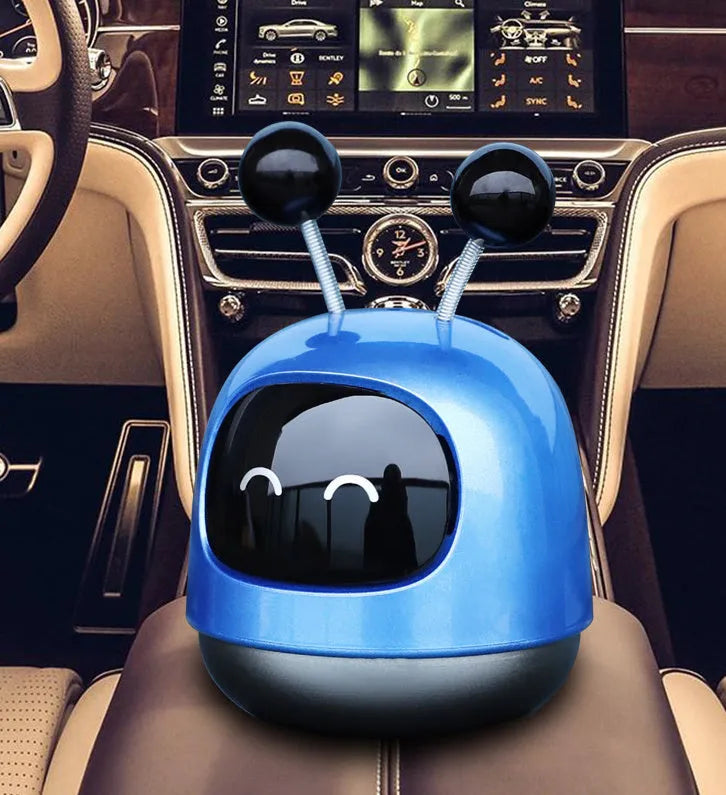 Blue robot car decorative ornament clipped to a car air vent as an aromatherapy diffuser.