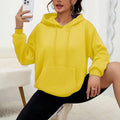Women's loose grey sweatshirt with long sleeves and a front drawstring pocket, shown in a relaxed fit.