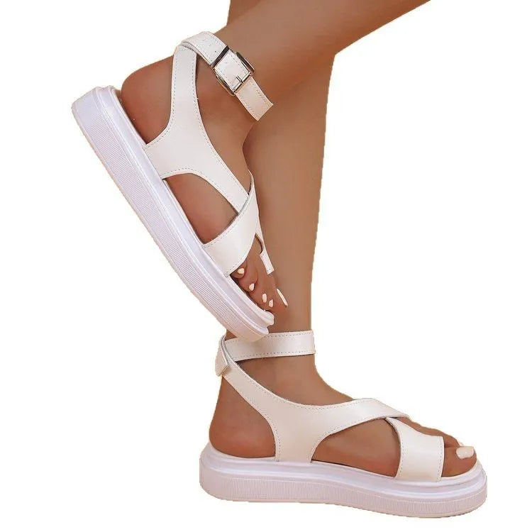 Women's white thick-soled Roman-style sandals with a buckle strap and lace loop fastening.