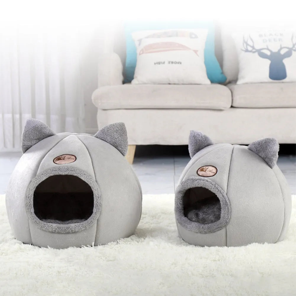 Large fully enclosed fabric cat house with a single entrance, shown in a home setting.