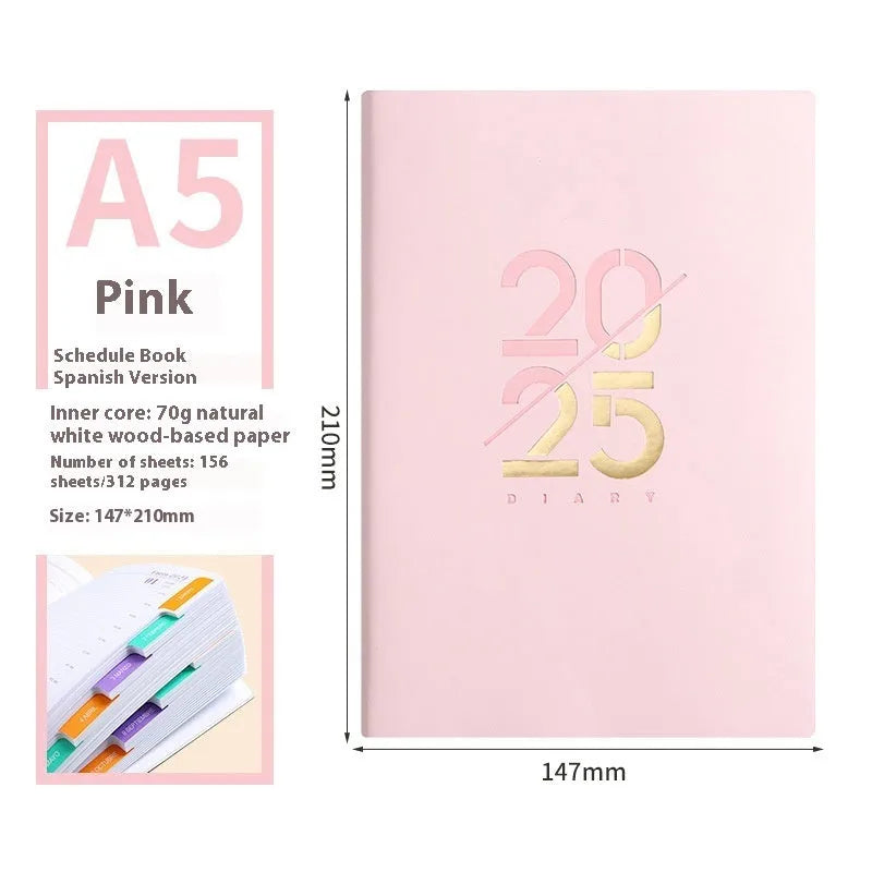 2025 A5 schedule book with faux leather cover in blue, showing open pages on a desk