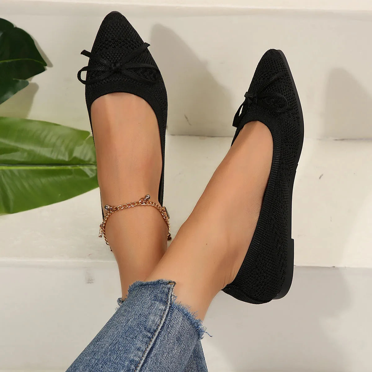 Women's knitted bow loafers with pointed-toe design in multiple colour options showing flat heel and rubber sole