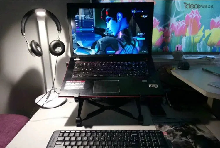 Black foldable portable laptop stand with enhanced nylon construction shown folded to 35.4cm with carrying case