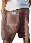 Men's grey corduroy shorts with multiple pockets and embroidery detail on a hanger.