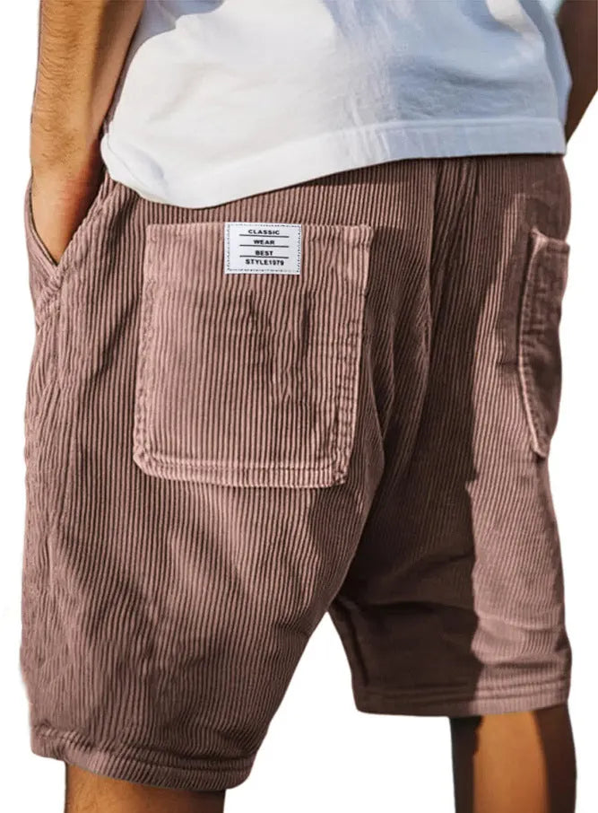 Men's grey corduroy shorts with multiple pockets and embroidery detail on a hanger.