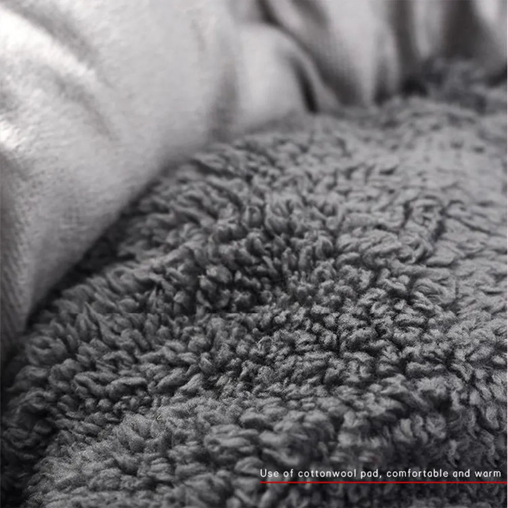 Grey round pet bed for small dogs and cats with raised edges and removable pillow on non-slip base