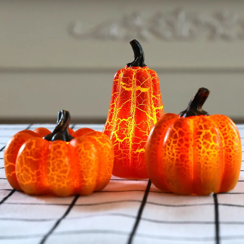 Set of three resin Halloween pumpkin lanterns with LED candle lights in short, medium, and long sizes.