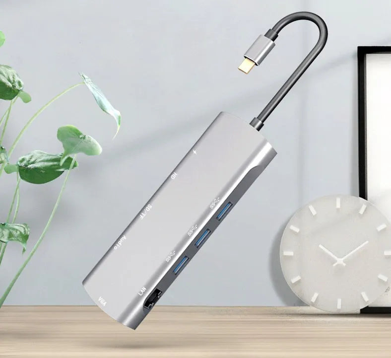 Grey USB-C docking station with HDMI, VGA, USB ports, and 140mm cable for laptop connectivity expansion