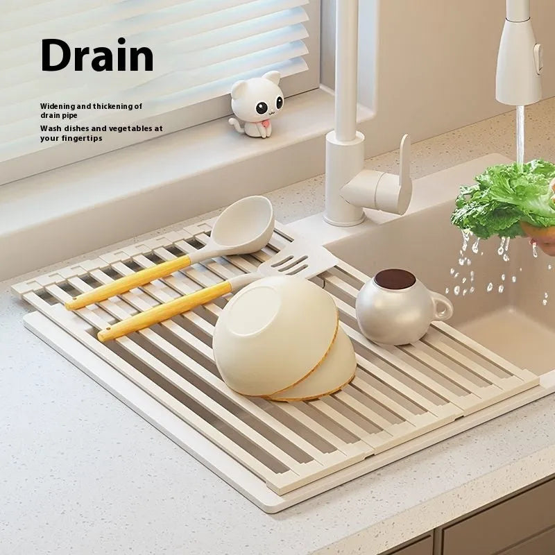 Milky white foldable stainless steel kitchen draining rack with tri-fold design on a sink