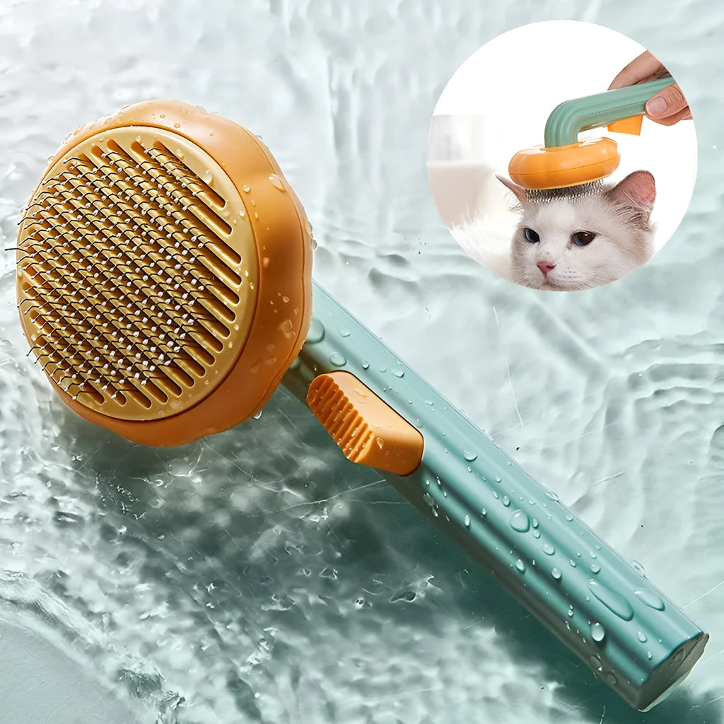 Pumpkin coloured hand-held pet grooming brush with stainless steel needles on a curved comb.