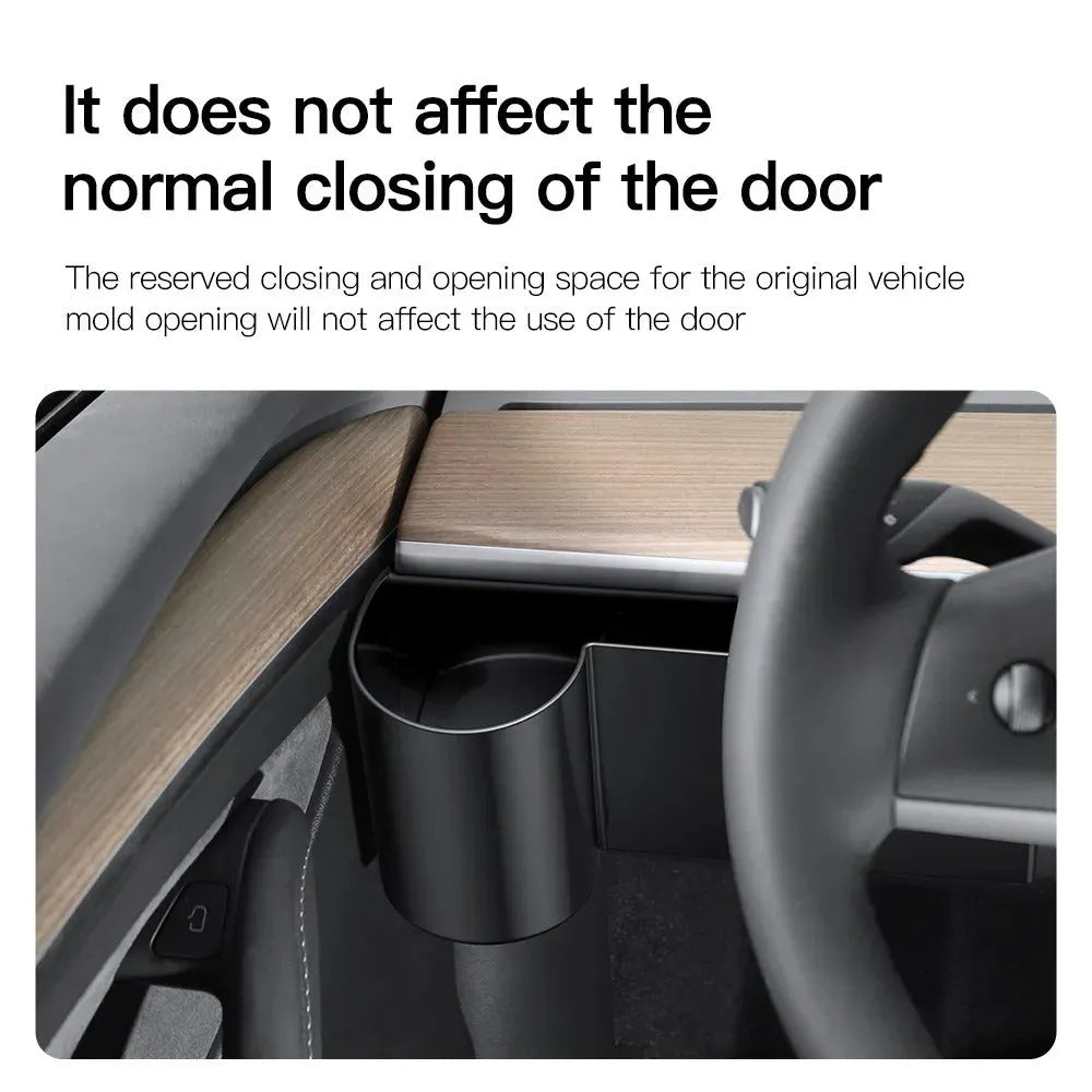 A plastic water cup holder designed for the dashboard of a left-hand drive Tesla Model 3 or Model Y.