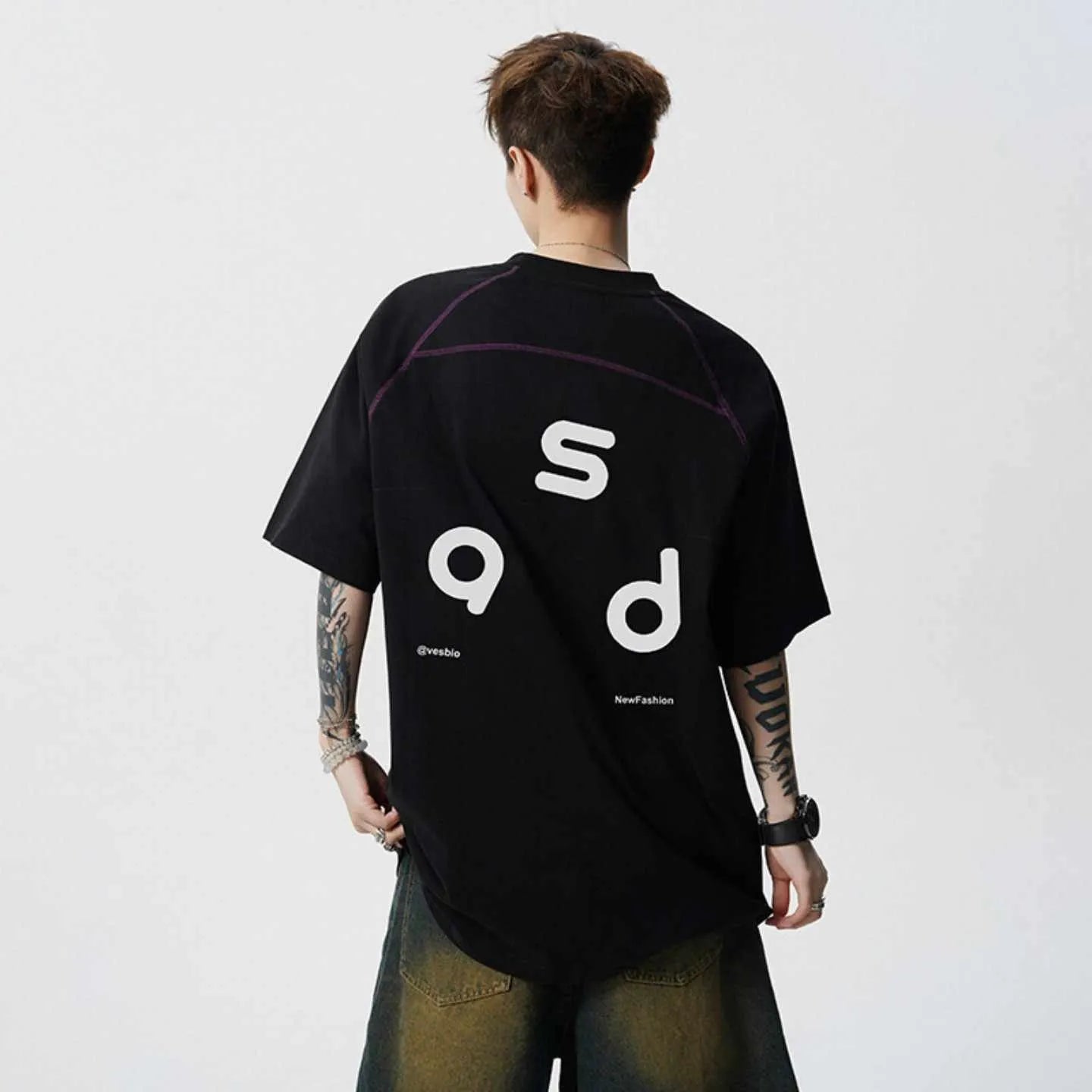 Men's loose fit black cotton T-shirt with a printed letter design on the front.
