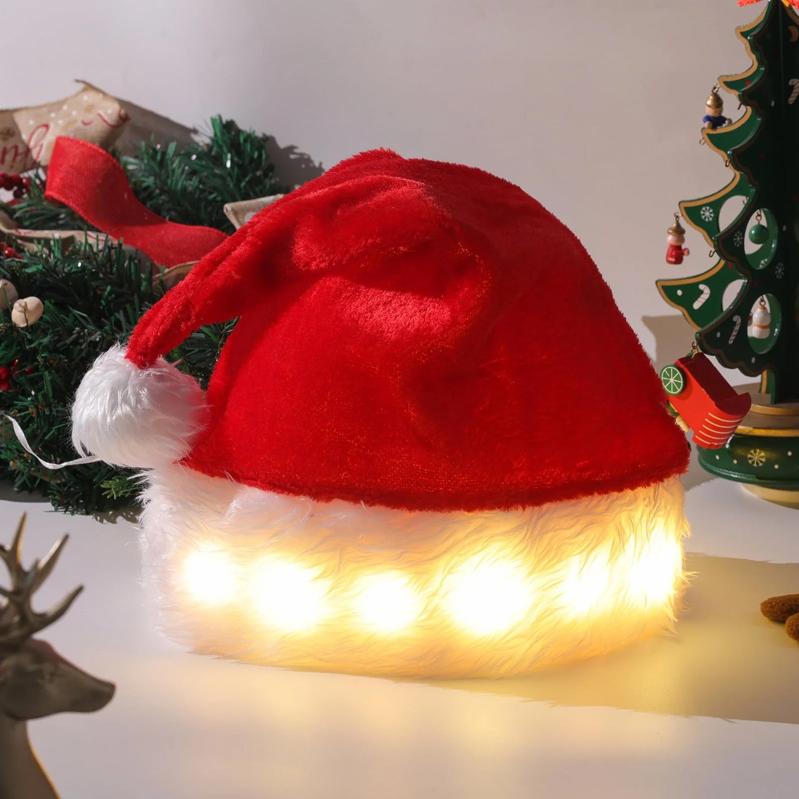 Red and white plush Santa hat with LED lights glowing around the brim and decorative pompom
