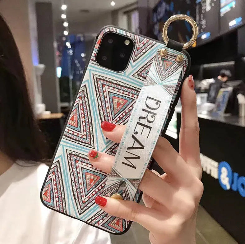 Rose floral wrist strap phone case for iPhone with secure strap attachment and decorative design.