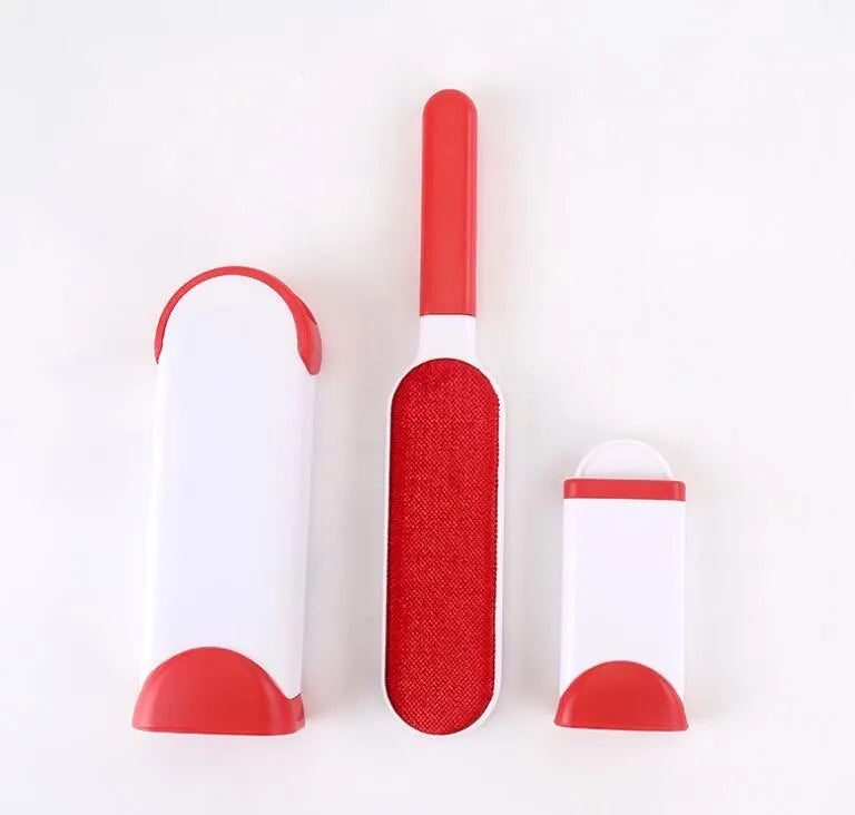 Blue reusable pet hair removal comb with double-sided flannel brush next to its self-cleaning base unit.