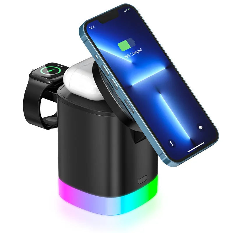 Black 3 in 1 magnetic wireless charging cube showing iPhone, Apple Watch and AirPods charging simultaneously with RGB lights