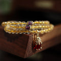 Natural Brazil gold rutilated quartz bracelet with three gold circles and ruby accents in Chinese-style design