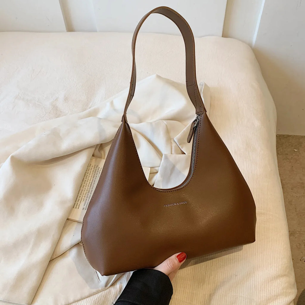 PU leather retro shoulder handbag in pillow shape with stitching details and single strap