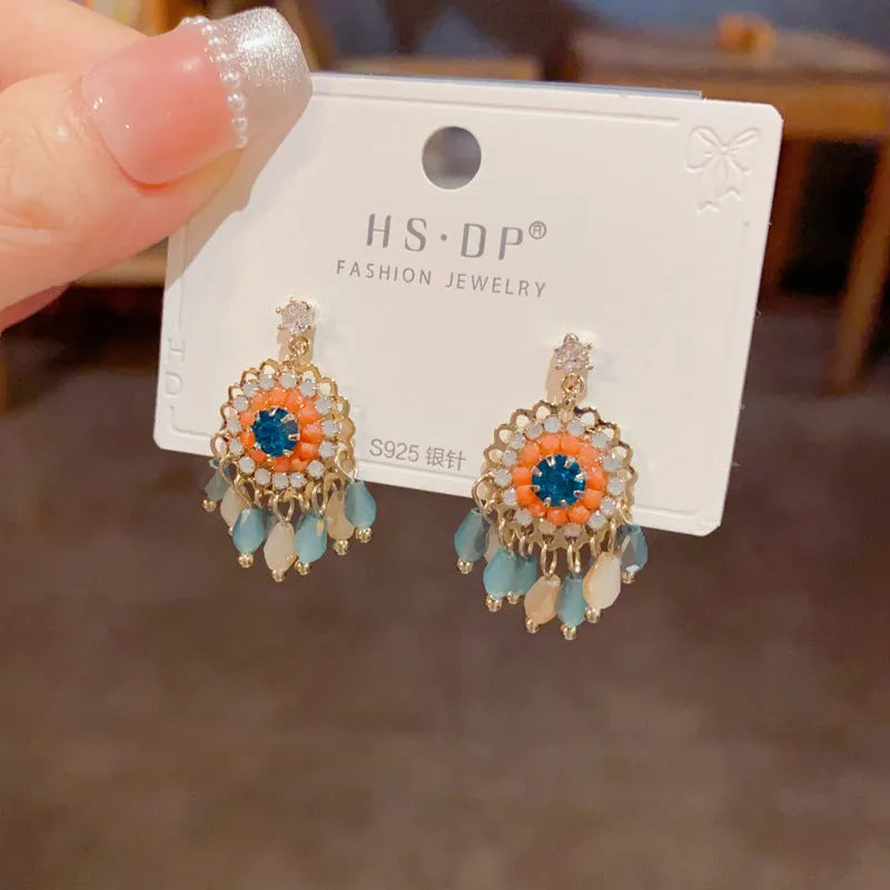 Purple and blue round crystal tassel earrings with diamond accents and thick gold plating