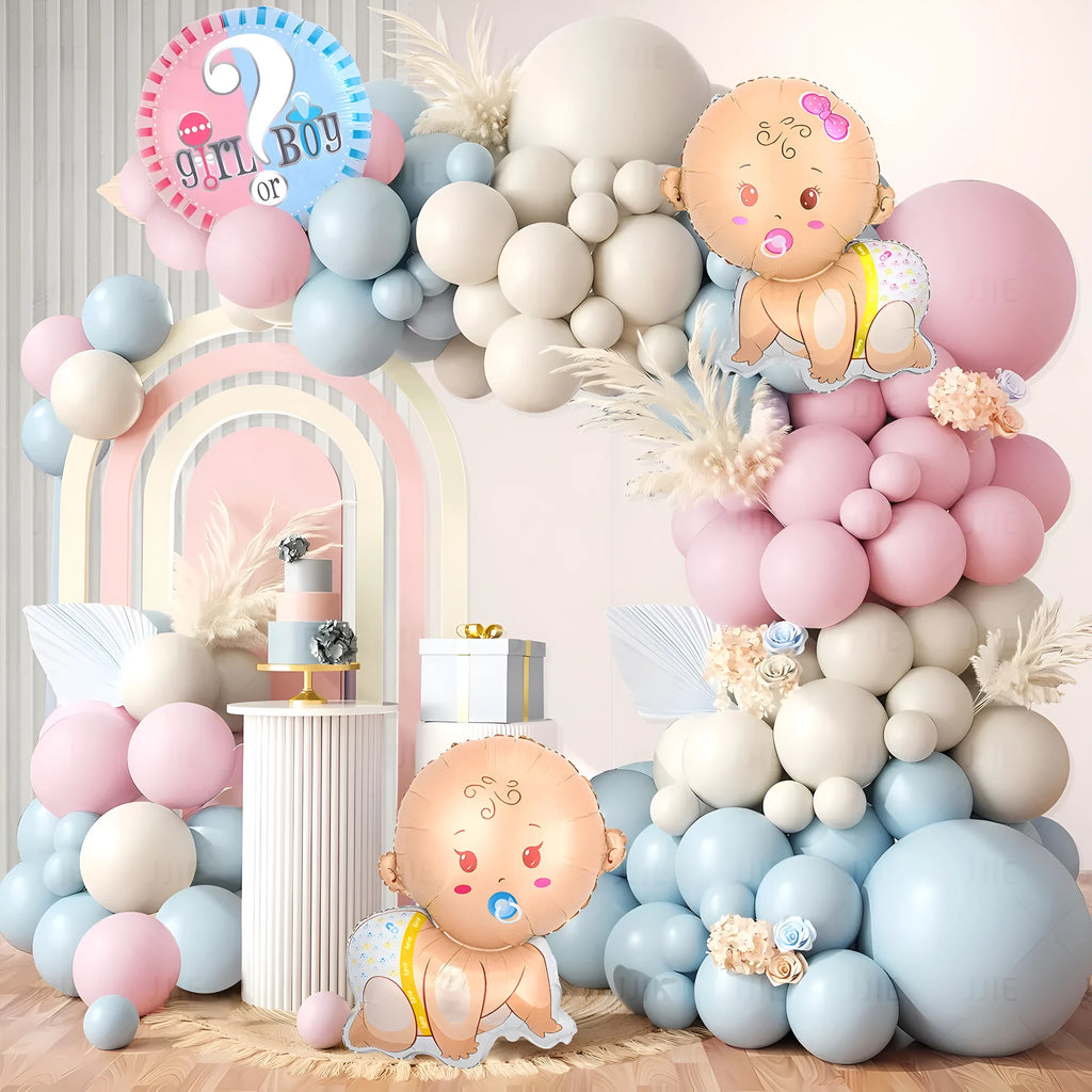 Gender reveal balloon decoration kit with pink and blue aluminium foil balloons, ribbon, and bottles.
