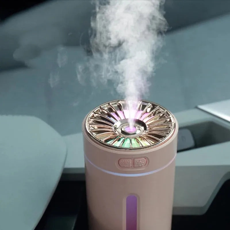 Black portable USB rechargeable humidifier with colourful LED lights on a car cup holder.