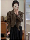Brown women's retro slim-fit imitation leather jacket with a pocket on a hanger.