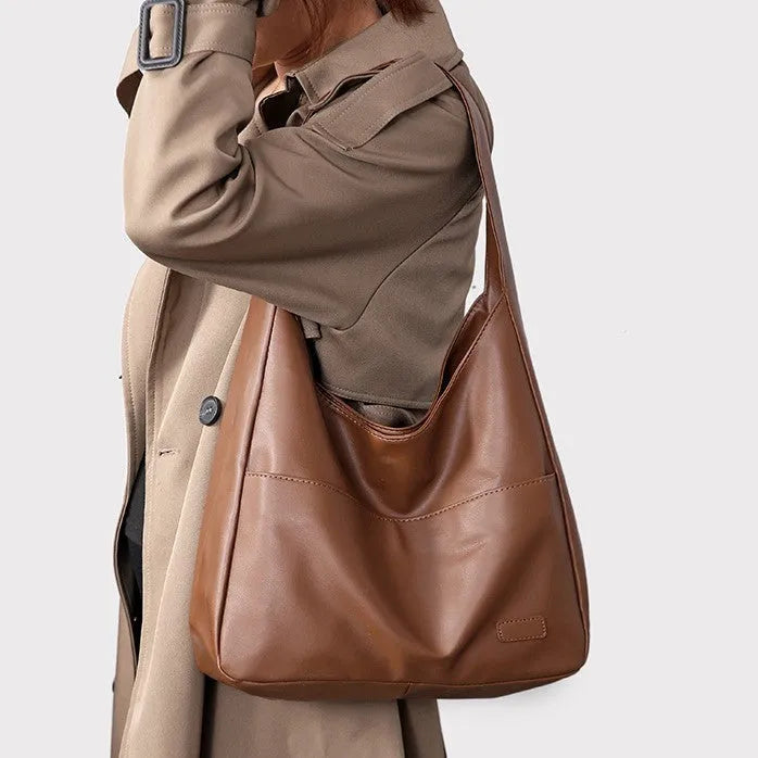 Women's soft PU leather shoulder bag in horizontal square shape showing internal zipper compartment