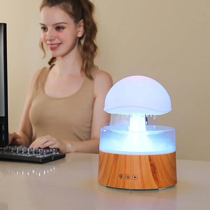 White rain cloud shaped humidifier with rainfall simulation and colour changing night light functions