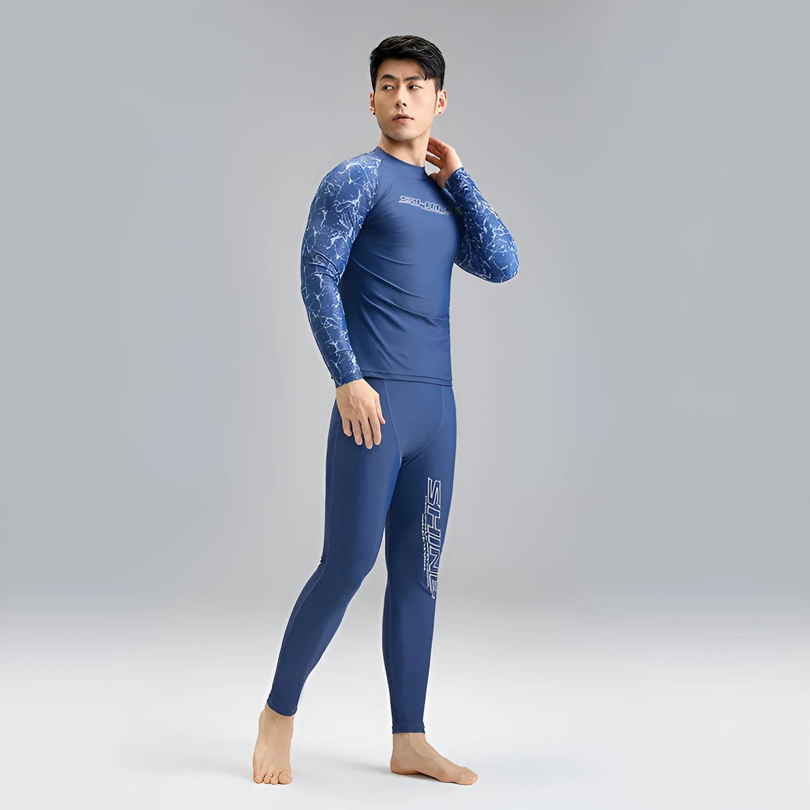 Dark blue men's swimwear set with patterned nylon top and matching swim trunks