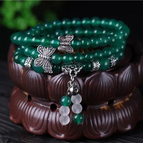 Close-up of a green agate multi-layer bracelet with three strands of 6mm round beads.